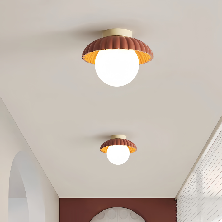 Ceiling lamp with a frosted shade providing warm lighting in the hallway