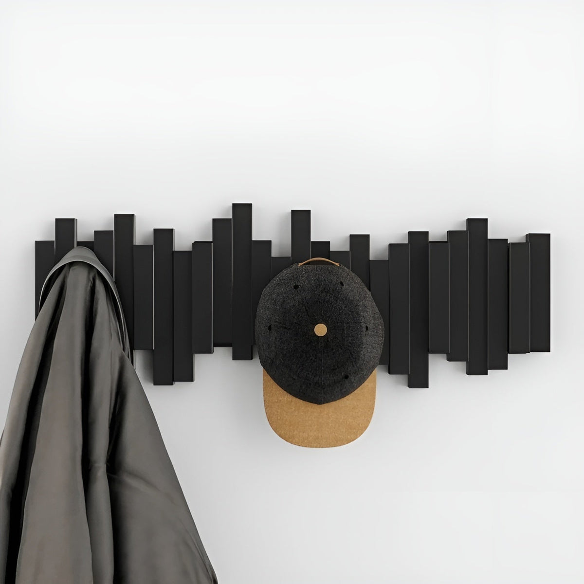 Porte-manteau mural avec crochets rabattables et mécanisme à touches de piano