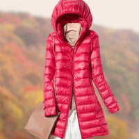 Veste longue matelassée à capuche et coupe ajustée pour femme