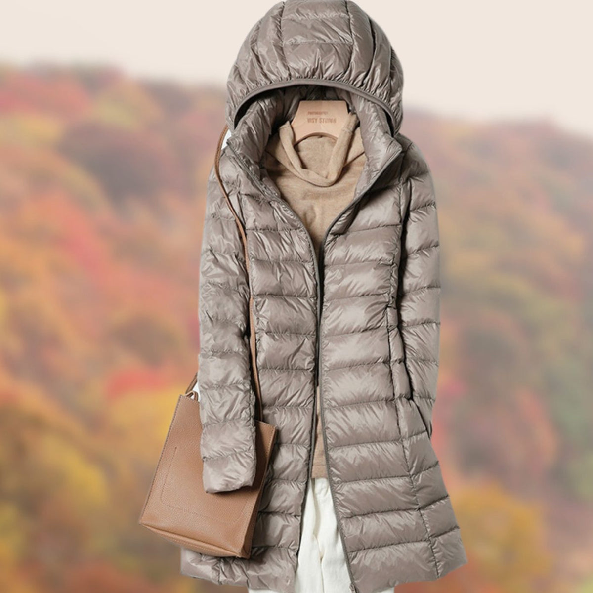 Veste longue matelassée à capuche et coupe ajustée pour femme