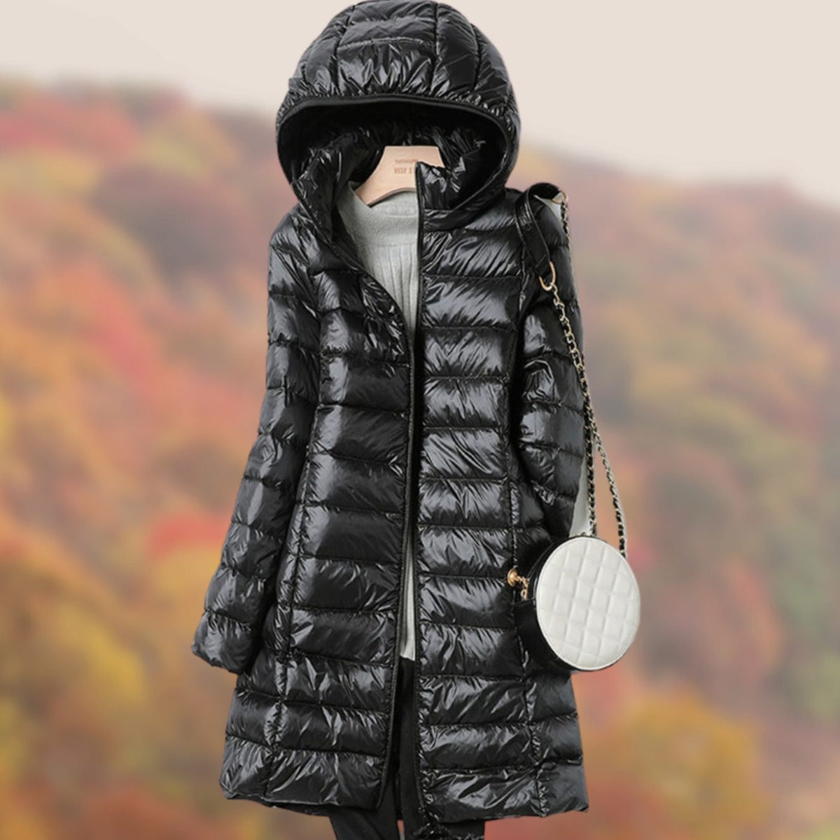Veste longue matelassée à capuche et coupe ajustée pour femme