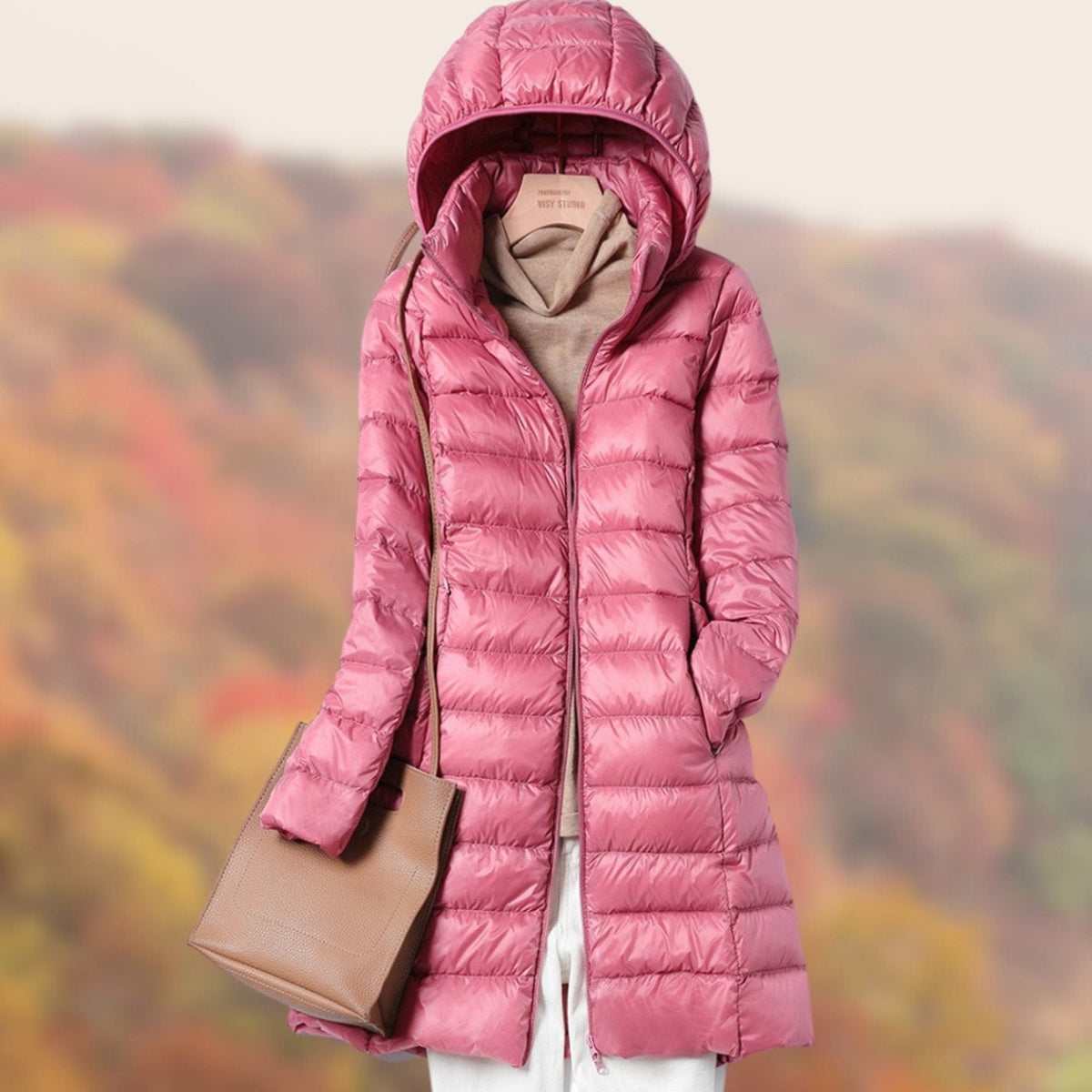 Veste longue matelassée à capuche et coupe ajustée pour femme